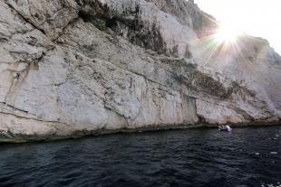 Boat is very small down the Cancéou cliff